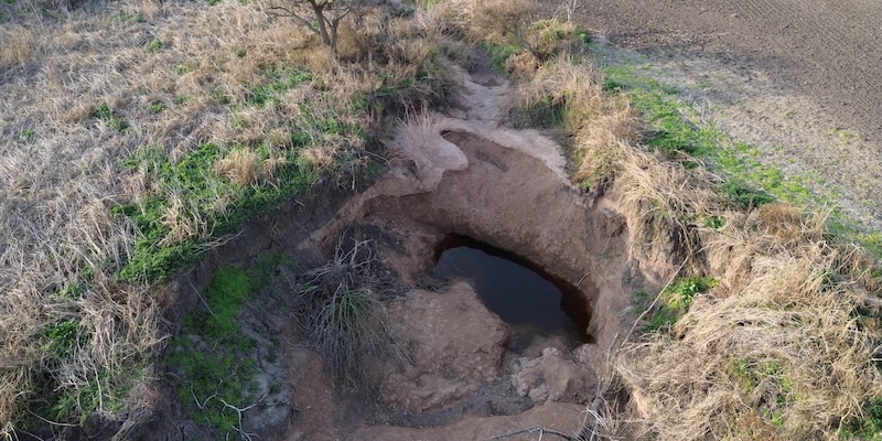 An eroded plot of land show unfiltered water in degraded soil in the Gómez Creek basin of Argentina