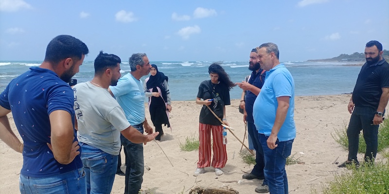 Community members attend a capacity building session on nesting turtles at the sand dunes in Kharayeb, Lebanon.
