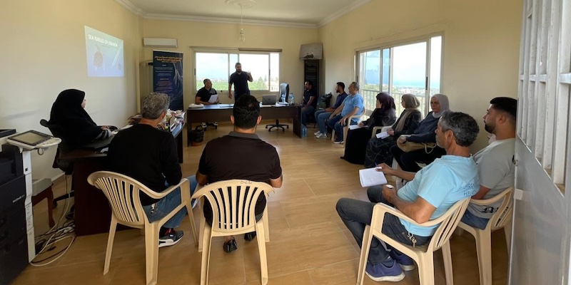 Community members attend a training session on marine biodiversity and climate change in Kharayeb, Lebanon.