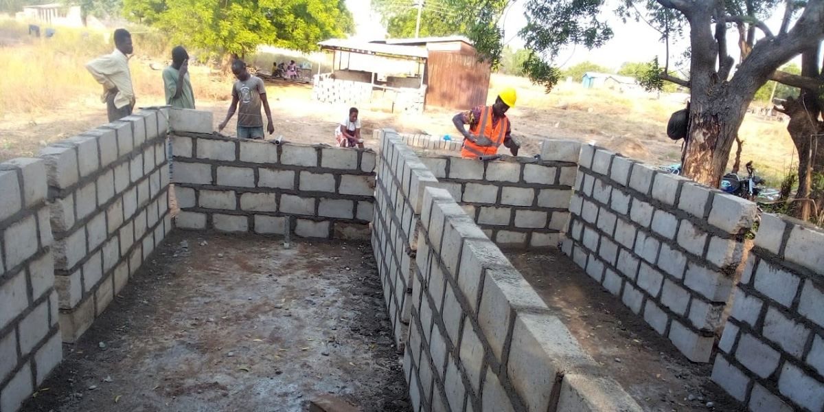 Community members work on the construction of water tanks for the aquaponics system in Ghana