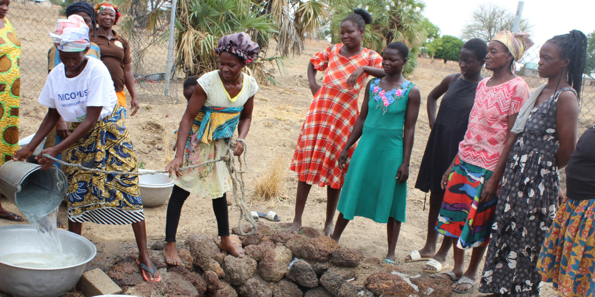 A group of women fetch water from a well in Ghana