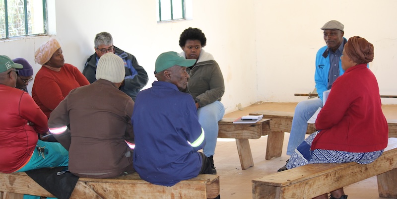 A group of members of the community gather together to plan next steps of the gardens.