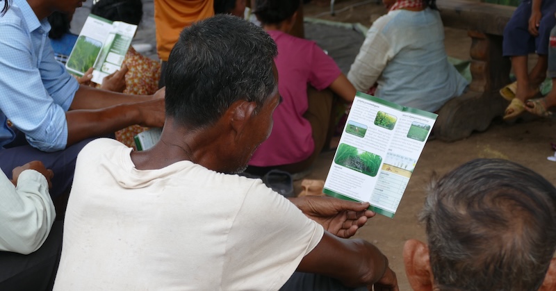 A man reads a leaflet during a training session in Cambodia.