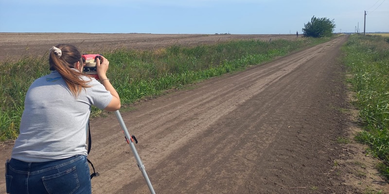 A woman stands on a plot of land in the Gómez Creek basin in Argentina to gather data.