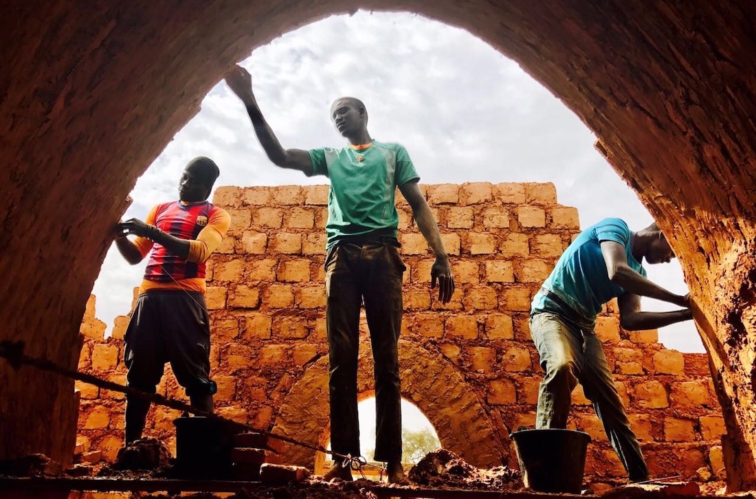Three men work in the construction of Nubian Vault houses using a technique originating in upper Egypt