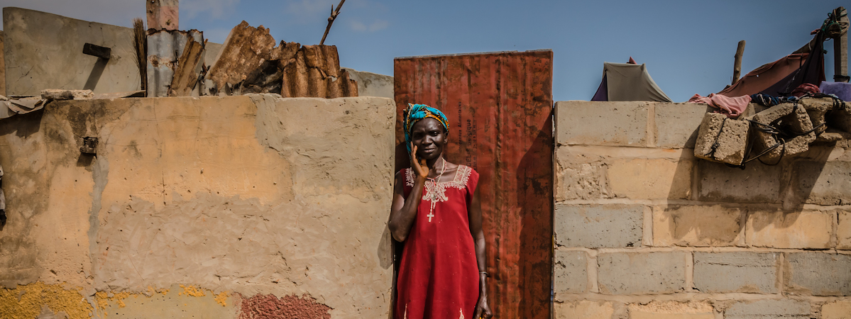 Senegalese woman standing in front of a door