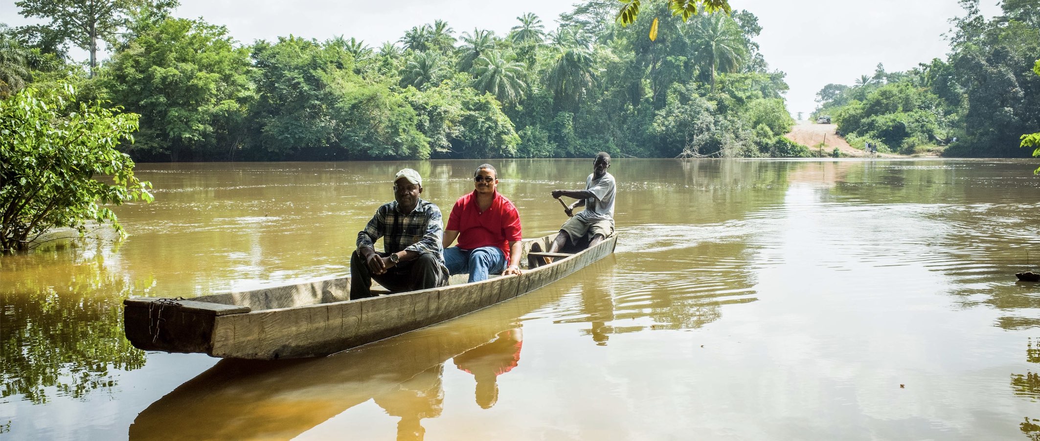 Two people in a boat on a river in Liberia 