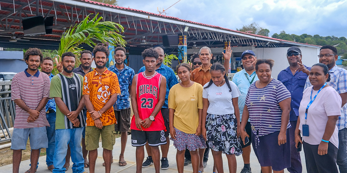 A group of young trainees and instructors stand together in Honiara, Solomon Islands, during a weather observer training programme.